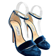 Three-quarter view of Jimmy Choo Misty 120 peacock blue velvet platform heels showing adjustable ankle buckles, open toes and covered stilettos.