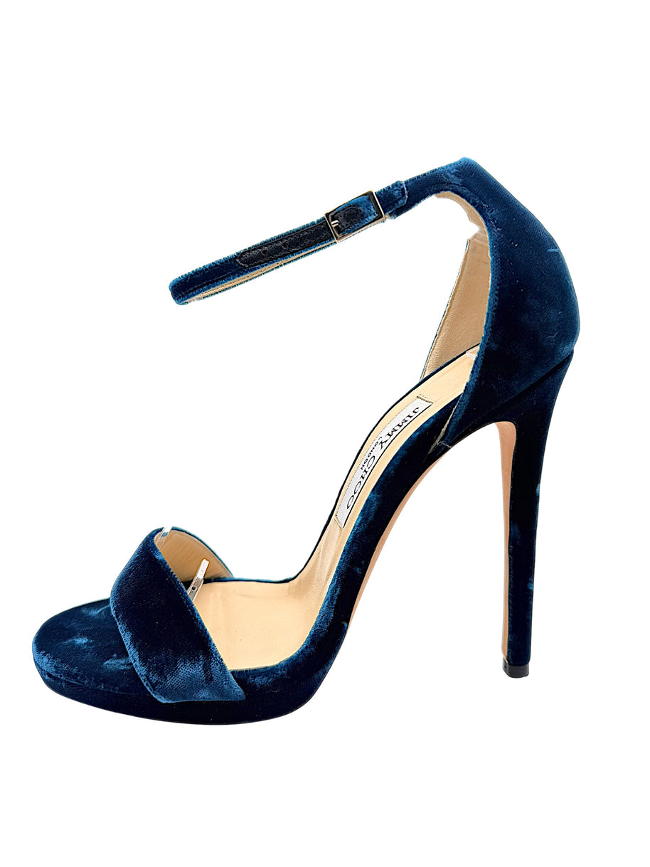 Underside of Jimmy Choo Misty 120 teal velvet heels showing original leather soles, EU 39 size markings and visible scuffing from previous wear.