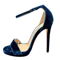 Underside of Jimmy Choo Misty 120 teal velvet heels showing original leather soles, EU 39 size markings and visible scuffing from previous wear.