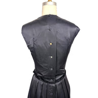 Close back detail of Lanvin Hiver 2005 black satin dress showing covered button closures and smooth satin finish.