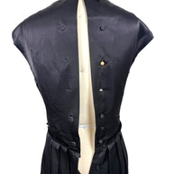 Interior back construction view of Lanvin Hiver 2005 black satin dress displaying covered button closures and interior finishing.