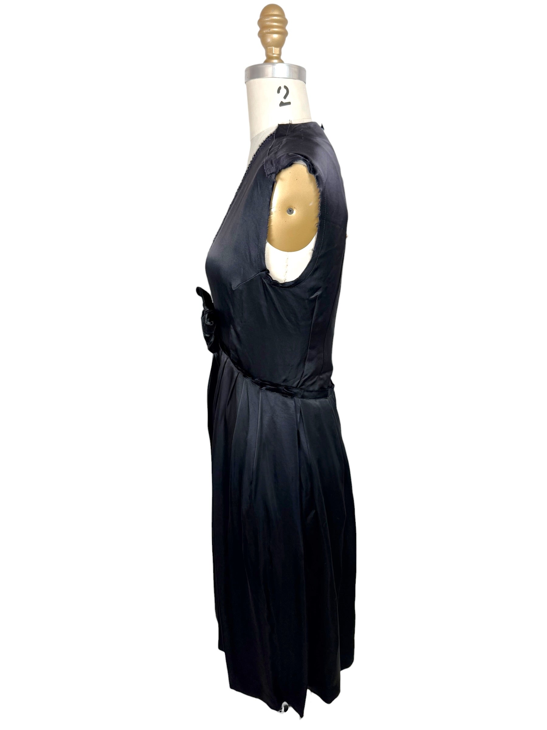 Right side profile of Lanvin Hiver 2005 black satin dress with pleated skirt and elegant minimalist silhouette.