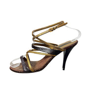Side detail of Louis Vuitton Monogram evening sandal showing metallic gold straps and dark brown textured detailing