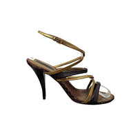 Side view of Louis Vuitton vintage strappy heel showing metallic gold wraparound ankle strap and stiletto heel