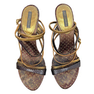Close top view of Louis Vuitton vintage sandals showing brown and gold Monogram footbeds, metallic gold straps and dark brown textured straps