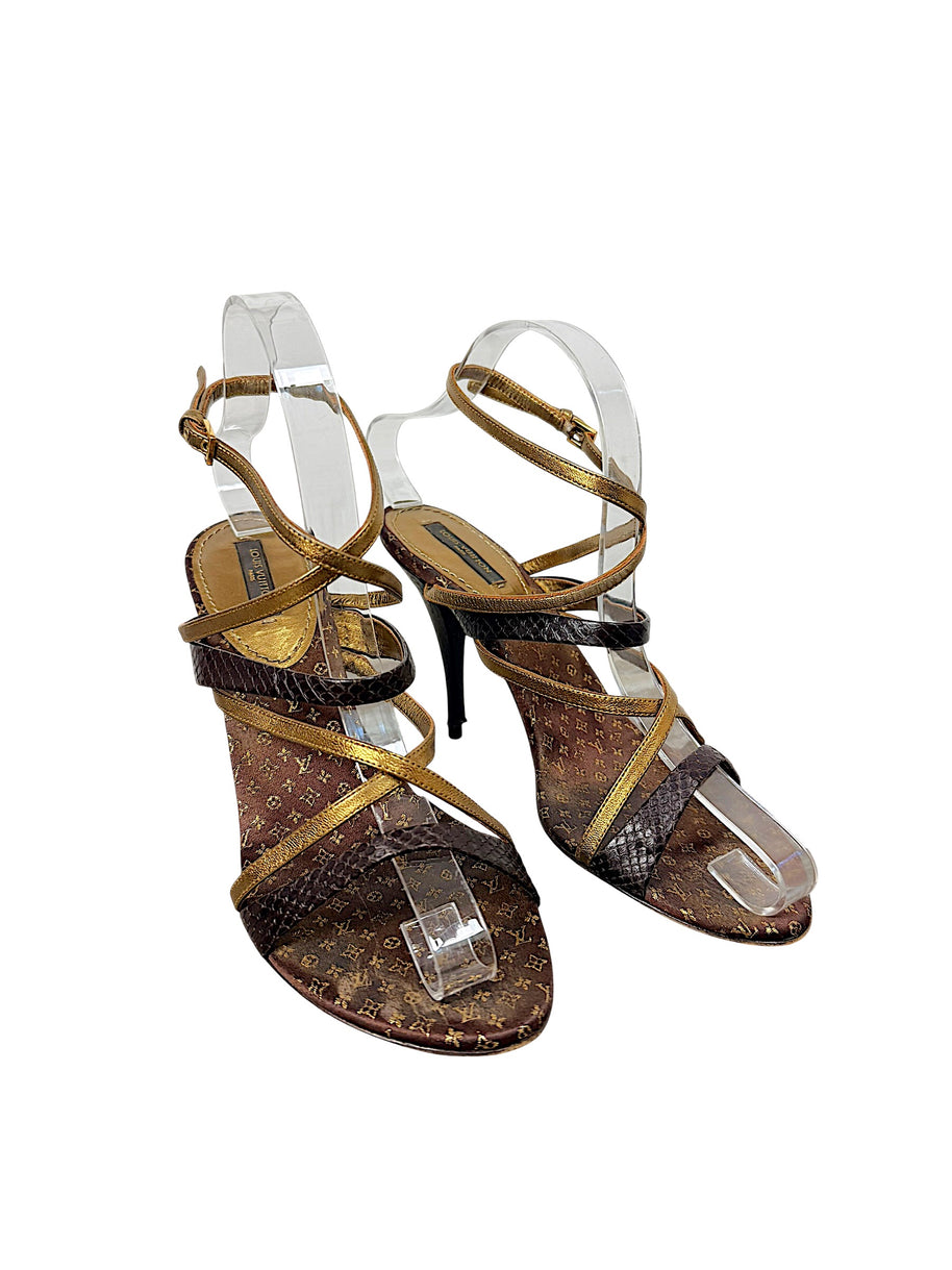 Three-quarter view of Louis Vuitton brown Monogram and metallic gold strappy high heel sandals