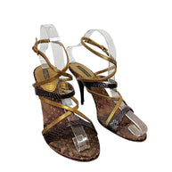 Three-quarter view of Louis Vuitton brown Monogram and metallic gold strappy high heel sandals