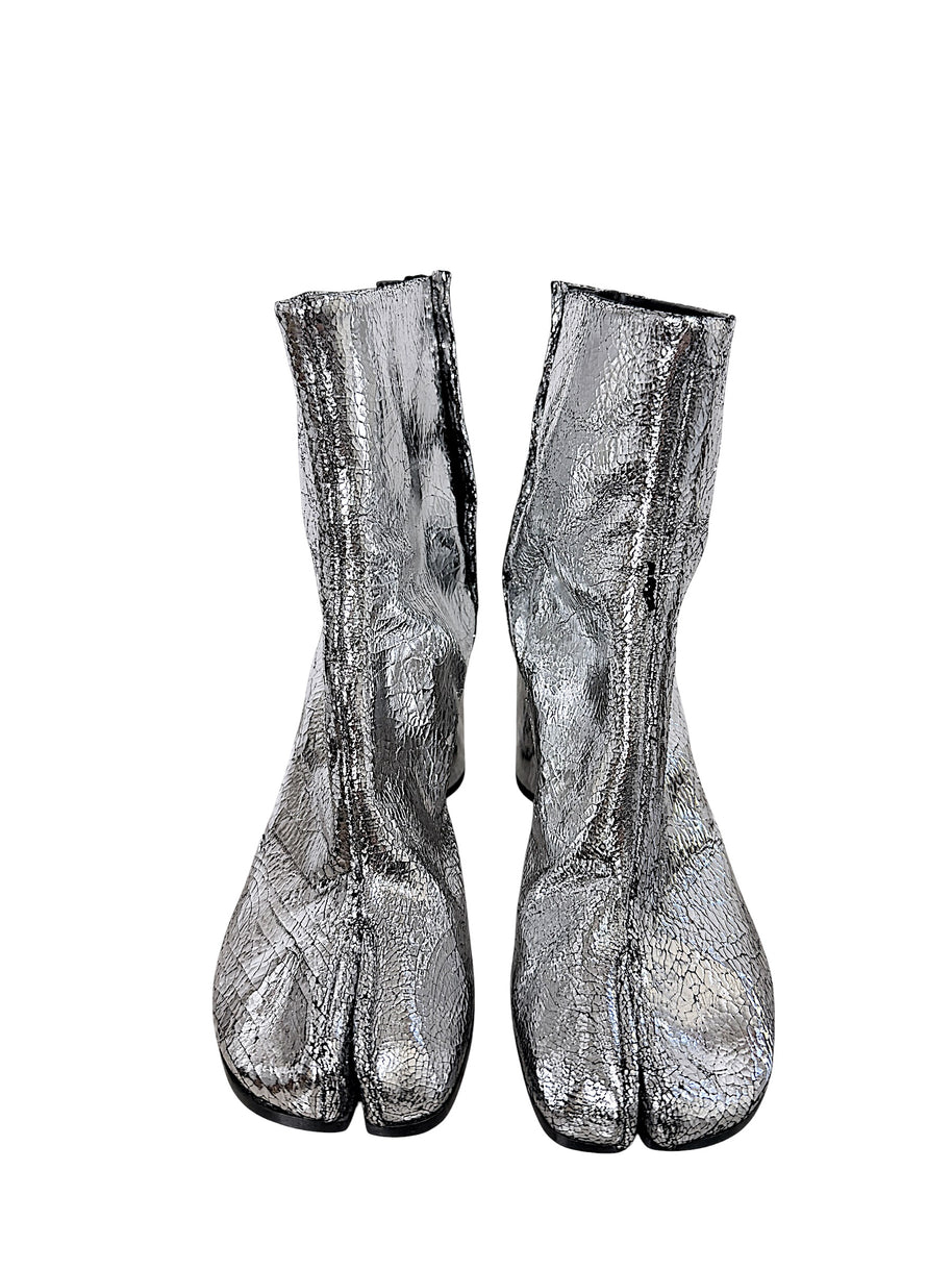 Front view of Maison Margiela metallic silver Tabi ankle boots showing signature split-toe design and distressed cracked finish