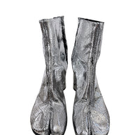 Front view of Maison Margiela metallic silver Tabi ankle boots showing signature split-toe design and distressed cracked finish