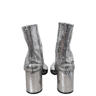 Rear view of Maison Margiela silver cracked leather Tabi ankle boots showing cylindrical block heels and signature white stitching