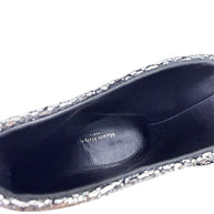 Close-up of black leather interior and Maison Margiela Paris logo inside silver metallic Tabi ankle boot