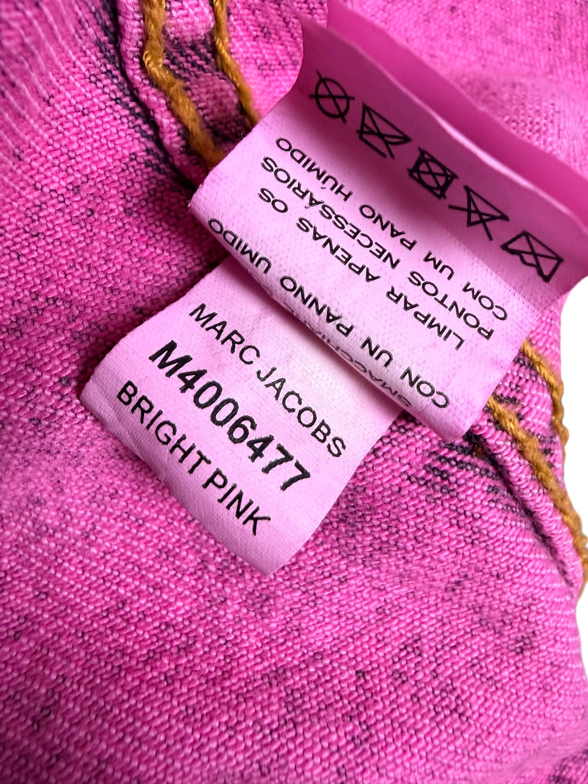 Marc Jacobs Paradise bright pink denim jacket interior care label showing style number M4006477, Bright Pink color designation and garment care instructions.