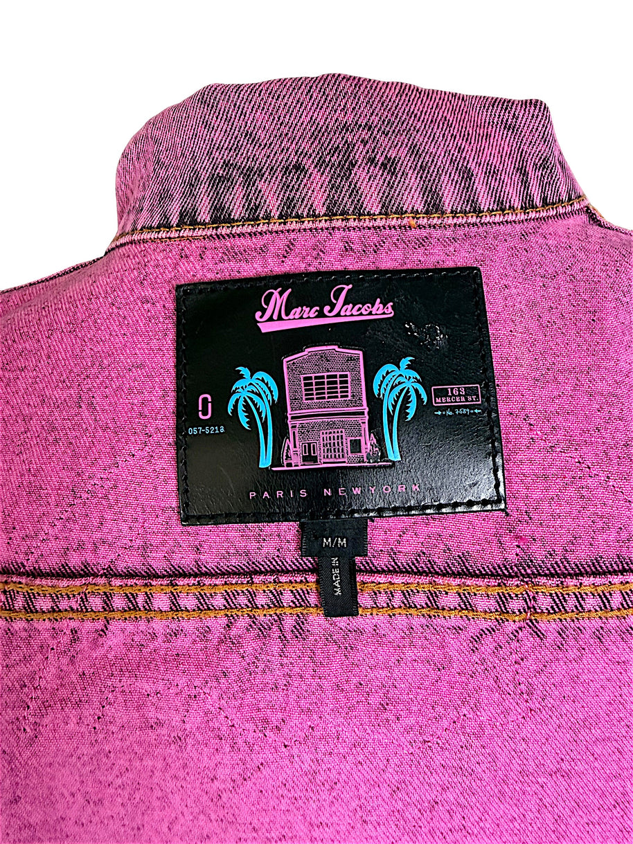 Close-up of Marc Jacobs designer label inside bright pink acid wash denim jacket, featuring tropical palm tree graphics, Paris New York branding and size M/M.