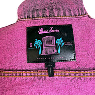 Close-up of Marc Jacobs designer label inside bright pink acid wash denim jacket, featuring tropical palm tree graphics, Paris New York branding and size M/M.