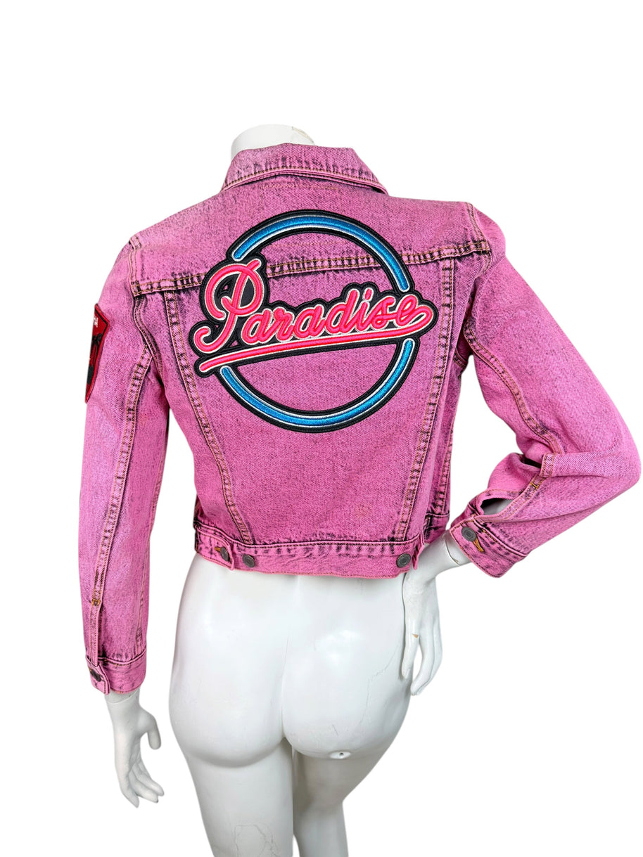 Back view of Marc Jacobs bright pink acid wash denim jacket featuring oversized blue, pink and black embroidered Paradise logo.