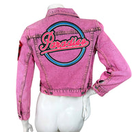Back view of Marc Jacobs bright pink acid wash denim jacket featuring oversized blue, pink and black embroidered Paradise logo.
