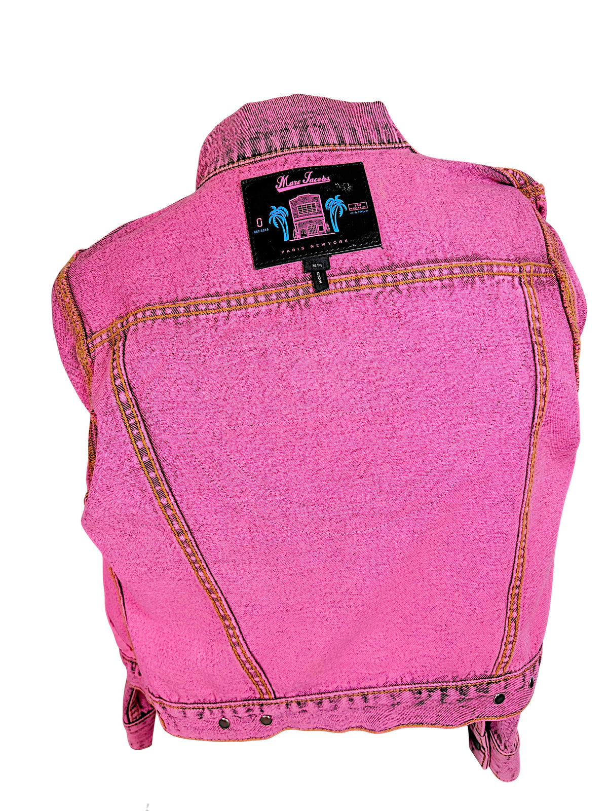 Interior view of Marc Jacobs Paradise pink denim jacket showing black designer label with tropical palm tree graphics and size Medium tag.