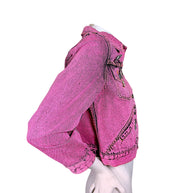 Side profile of Marc Jacobs Paradise pink acid wash denim trucker jacket showing cropped hem, structured shoulder and long button-cuff sleeve.