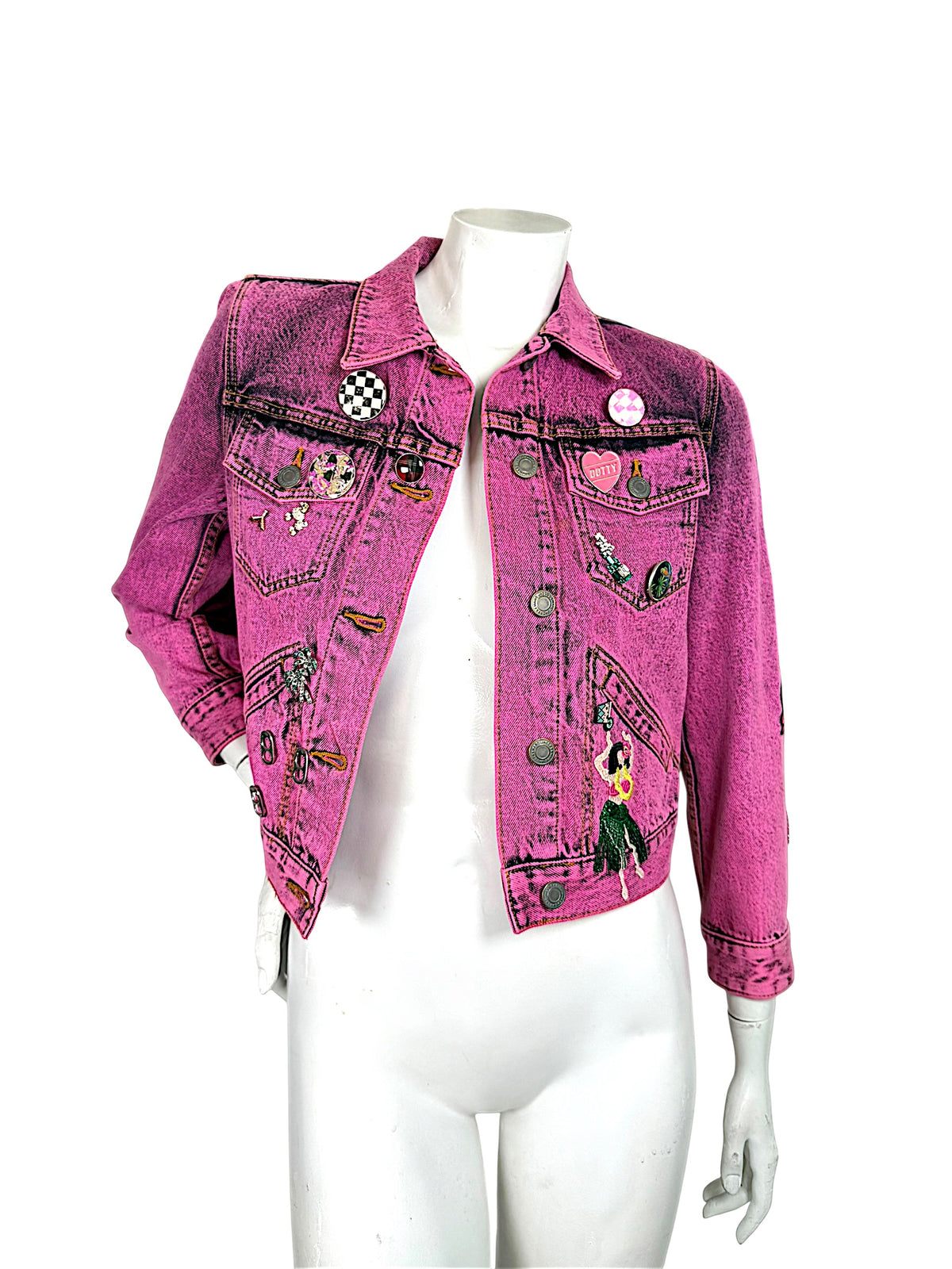 Marc Jacobs Paradise bright pink acid wash cropped denim jacket with embroidered tropical motifs and decorative pins, shown open on mannequin.