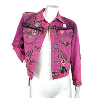 Marc Jacobs Paradise bright pink acid wash cropped denim jacket with embroidered tropical motifs and decorative pins, shown open on mannequin.