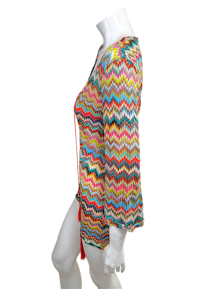 Side profile of Missoni Mare multicolor knit beach cover-up dress with lightweight semi-sheer zigzag fabric and tasseled neckline ties.