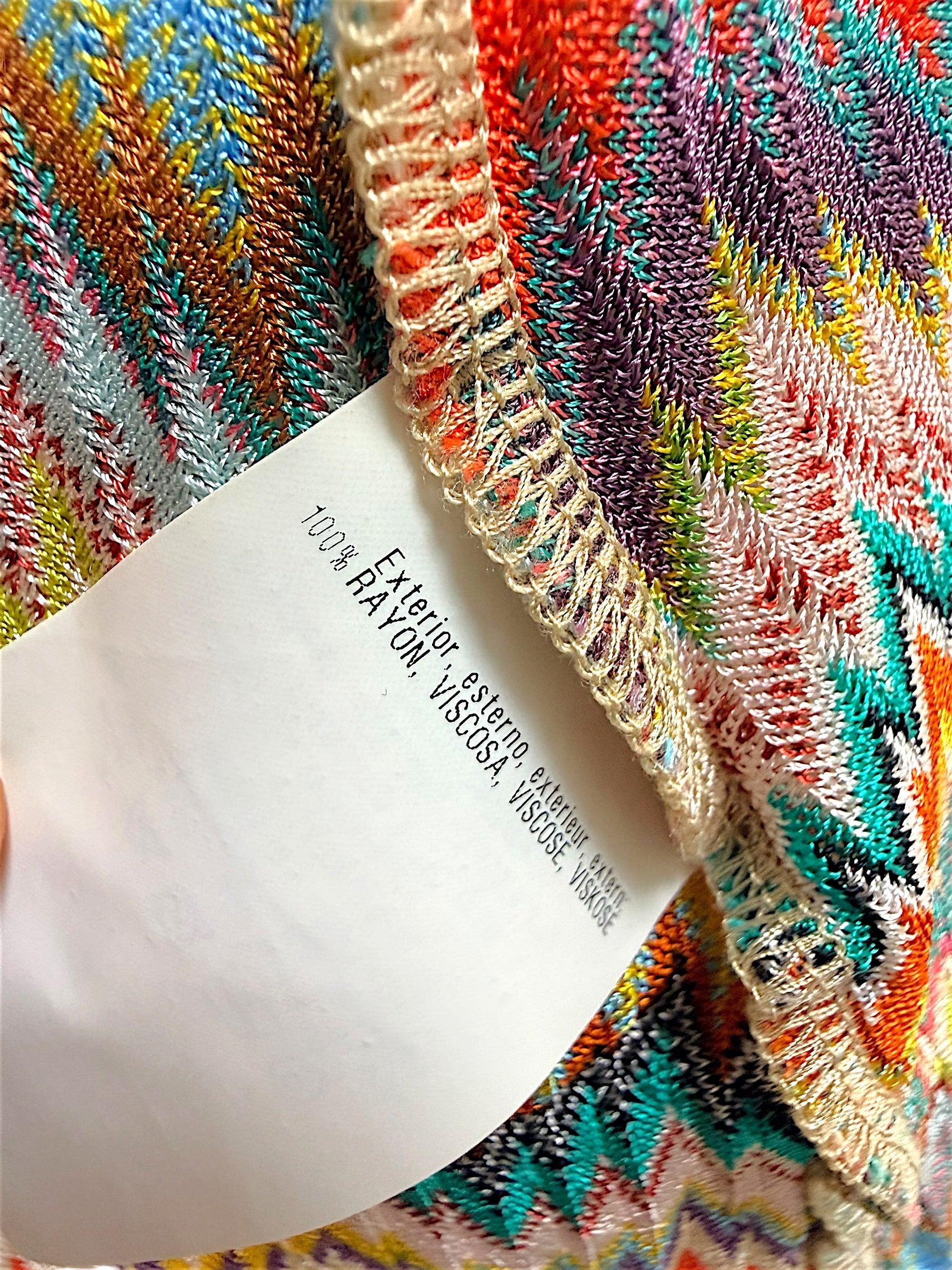 Close-up of Missoni garment fabric composition tag showing 100 percent rayon viscose material.