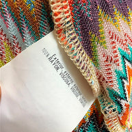 Close-up of Missoni garment fabric composition tag showing 100 percent rayon viscose material.