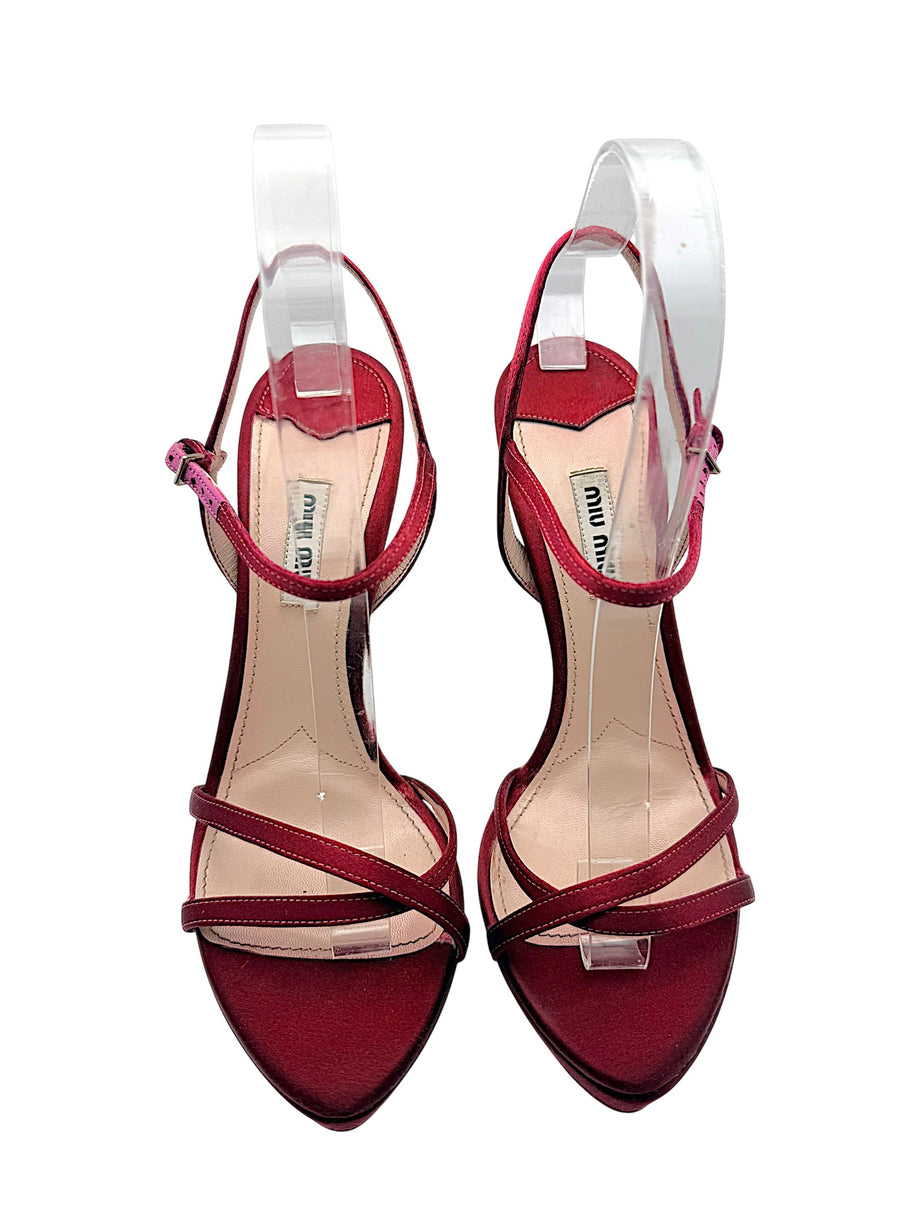 Front view of Miu Miu burgundy satin platform sandals with open toes, crossed satin straps, ankle closures and branded leather insoles.
