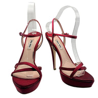 Front angled view of Miu Miu burgundy satin platform stiletto sandals with crossover toe straps and adjustable ankle buckles, size EU 39.