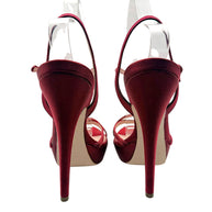 Rear view of Miu Miu burgundy satin platform heels showing tall satin-covered stilettos, heel tips and slender ankle straps.