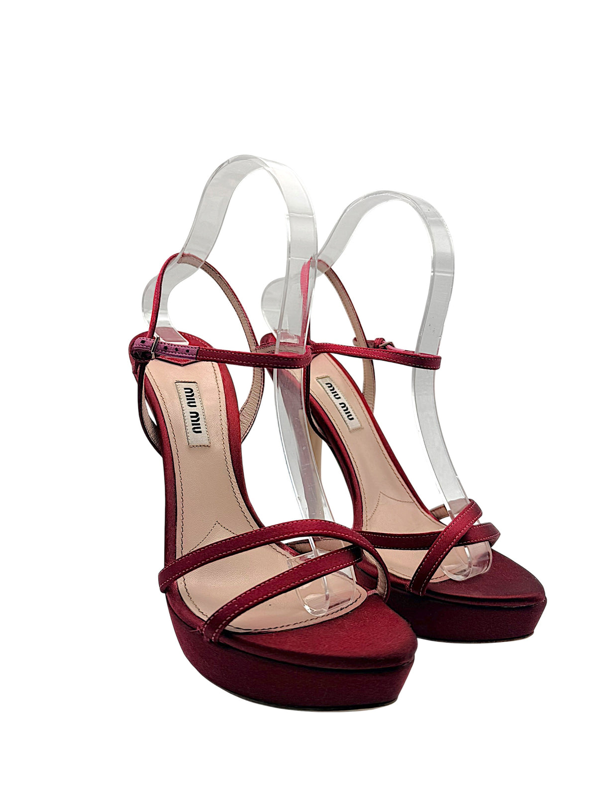 Pair of Miu Miu burgundy satin high heel sandals showing delicate crisscross front straps, covered platforms and slim stiletto heels.