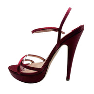 Opposite side view of a Miu Miu burgundy satin stiletto sandal highlighting its curved arch, raised platform and delicate ankle strap.