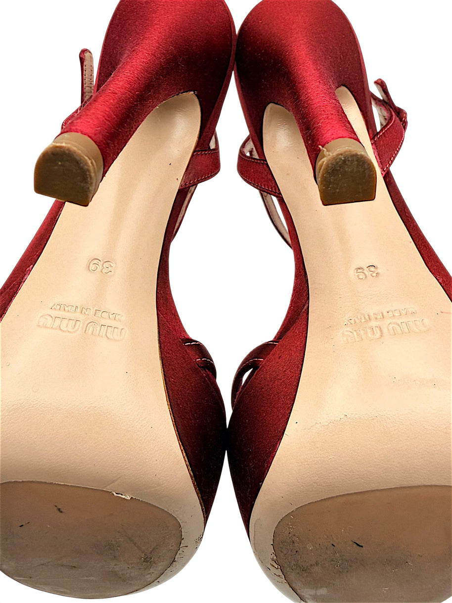 Close-up of Miu Miu leather outsoles showing embossed designer branding, Made in Italy markings, EU 39 size stamps and signs of use.