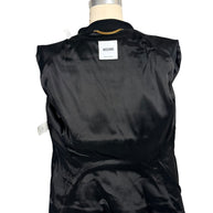 Interior view of Moschino black peplum jacket showing the smooth black lining, Moschino Made in Italy designer label, neckline chain and interior construction.