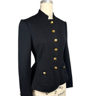 Three-quarter front view of Moschino black Italian tailored jacket highlighting its sculpted waist, gold-tone button closure and rounded front patch pocket.