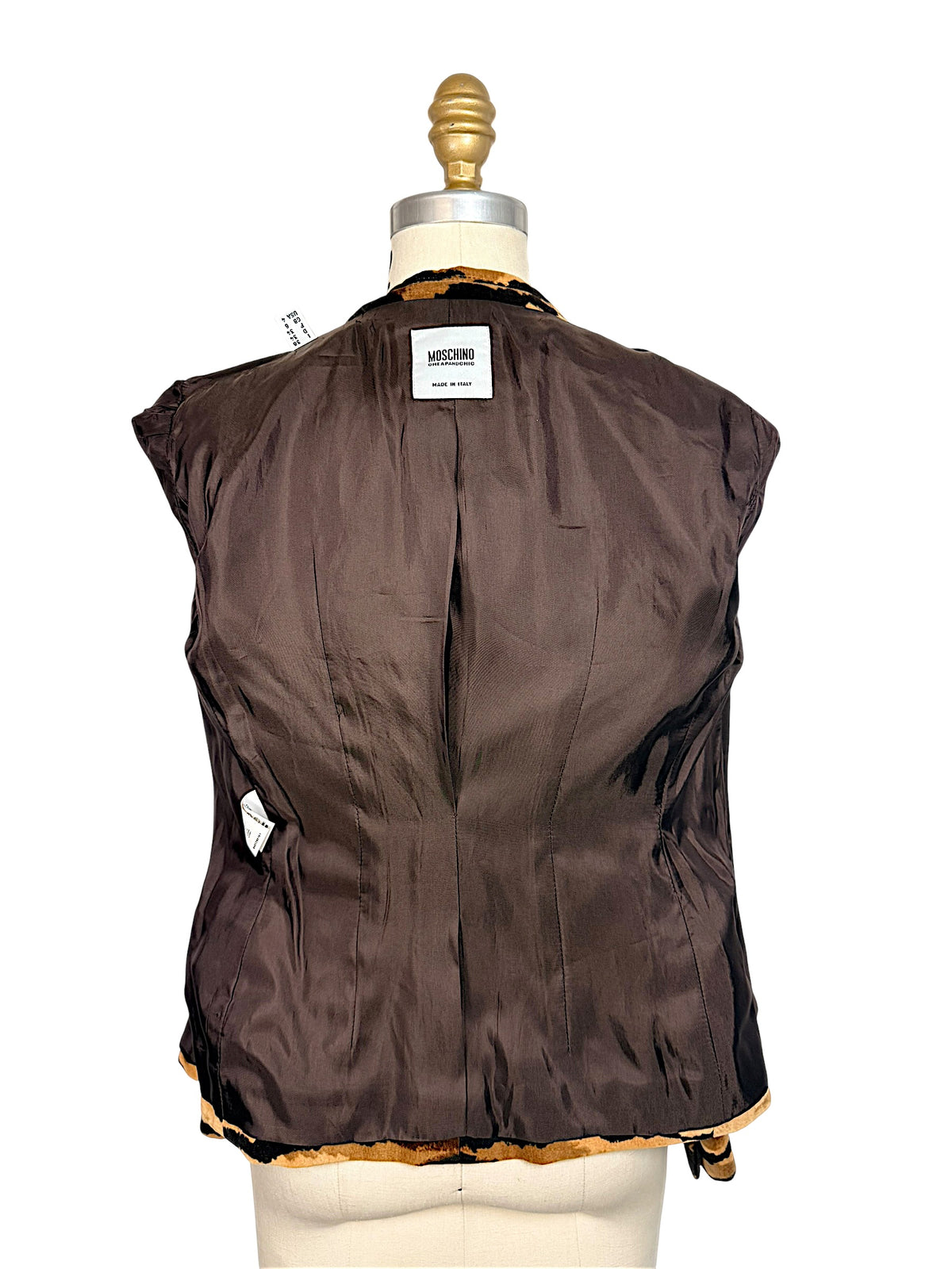 Inside-out back view of Moschino Cheap and Chic tiger-print blazer showing smooth brown lining and interior construction.