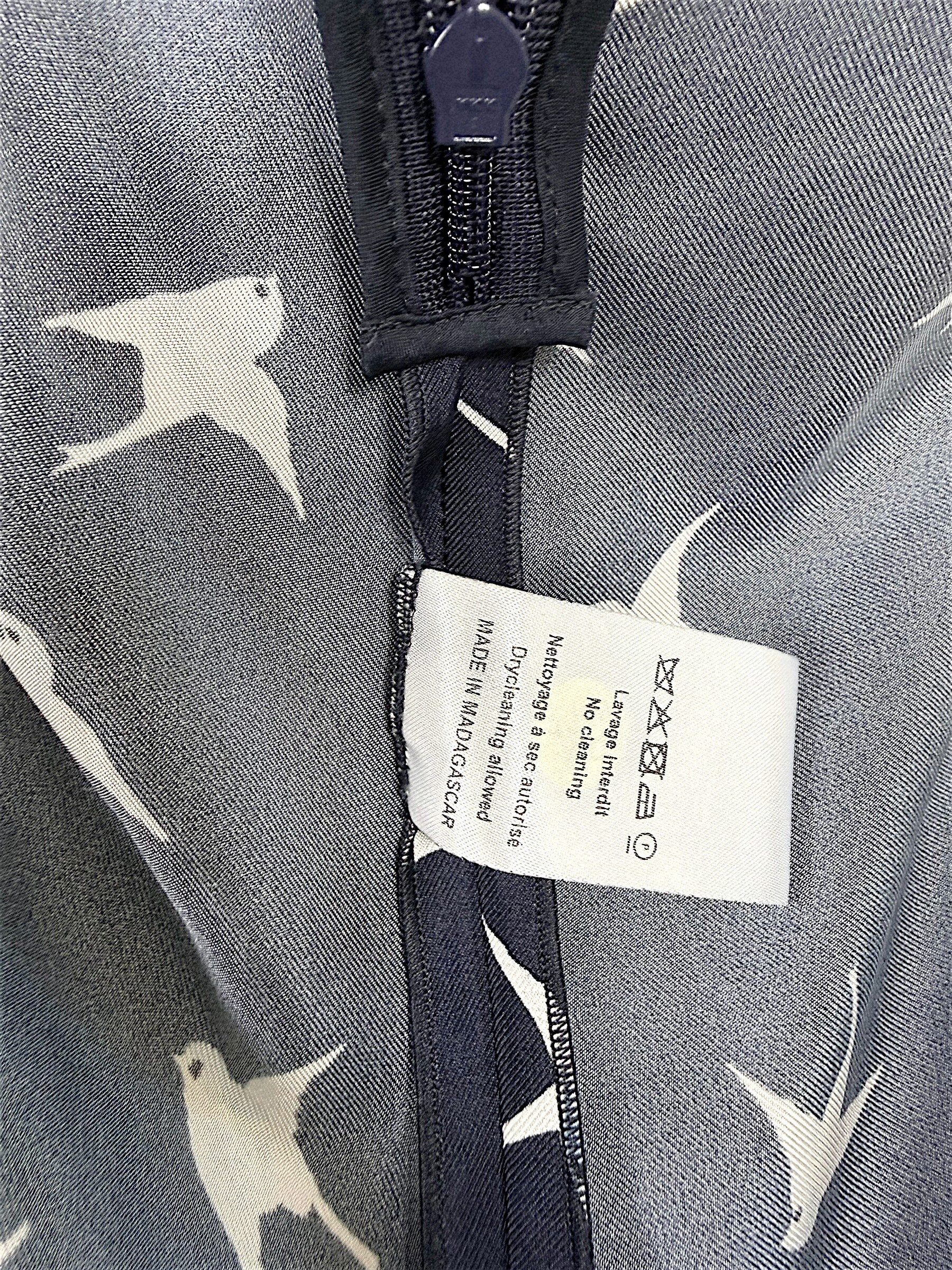 Interior care tag and seam construction detail of Nina Ricci navy silk bird print dress.