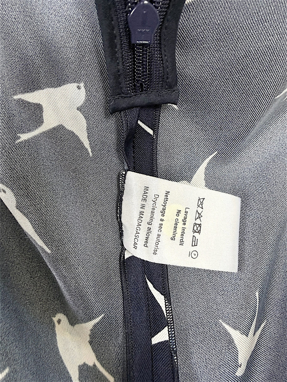 Interior care tag and seam construction detail of Nina Ricci navy silk bird print dress.
