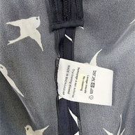 Interior care tag and seam construction detail of Nina Ricci navy silk bird print dress.