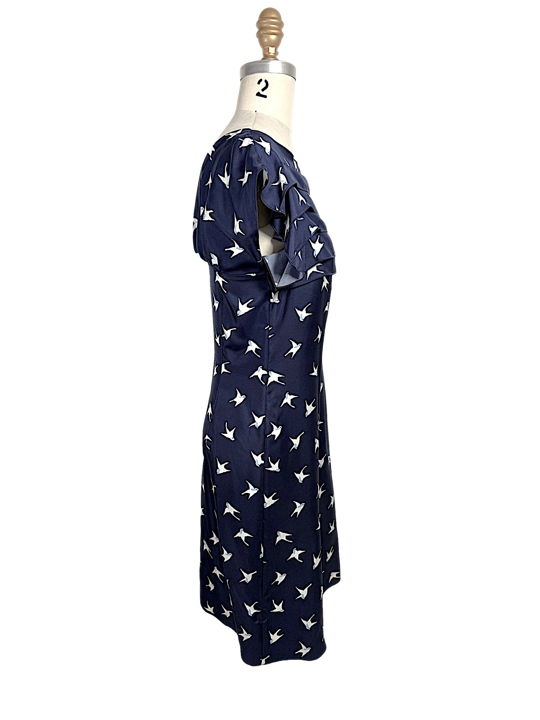 Right side profile of Nina Ricci silk bird print dress with structured waist and layered ruffle bodice.