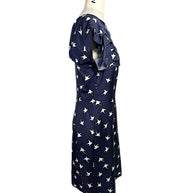 Right side profile of Nina Ricci silk bird print dress with structured waist and layered ruffle bodice.