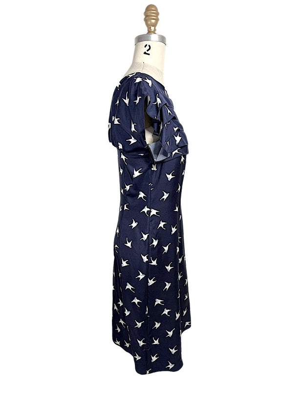 Right side profile of Nina Ricci silk bird print dress with structured waist and layered ruffle bodice.