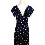 Back view of Nina Ricci navy silk dress with deep V open back and ivory bird print throughout.
