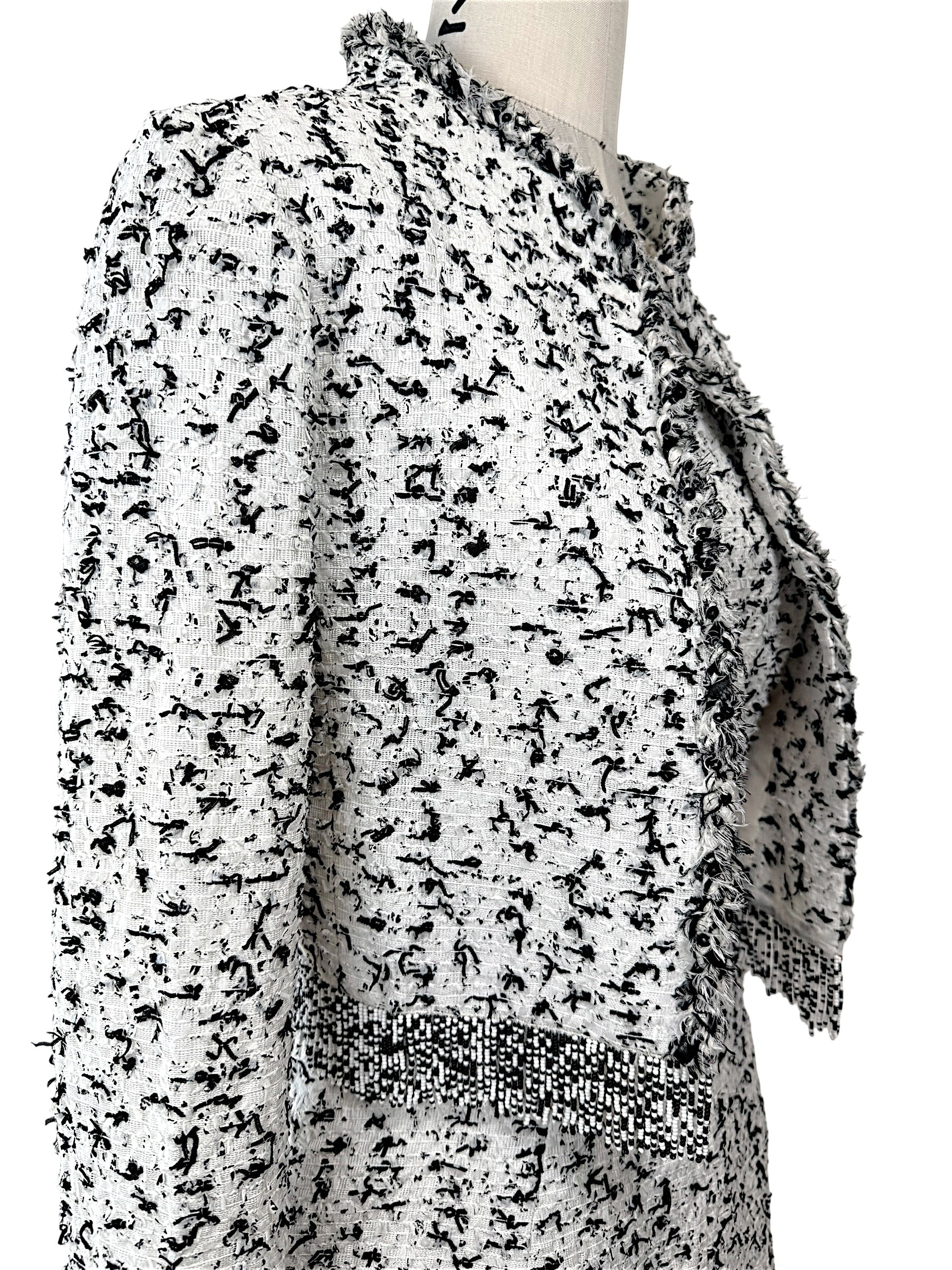 Oscar de la Renta tweed jacket fabric detail close-up black white woven texture fringe trim
