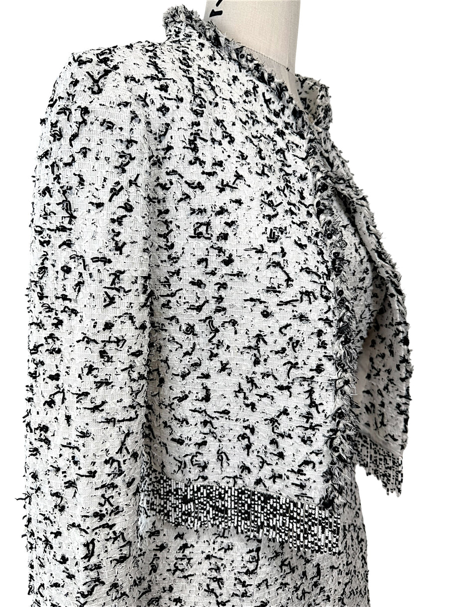 Oscar de la Renta tweed jacket fabric detail close-up black white woven texture fringe trim