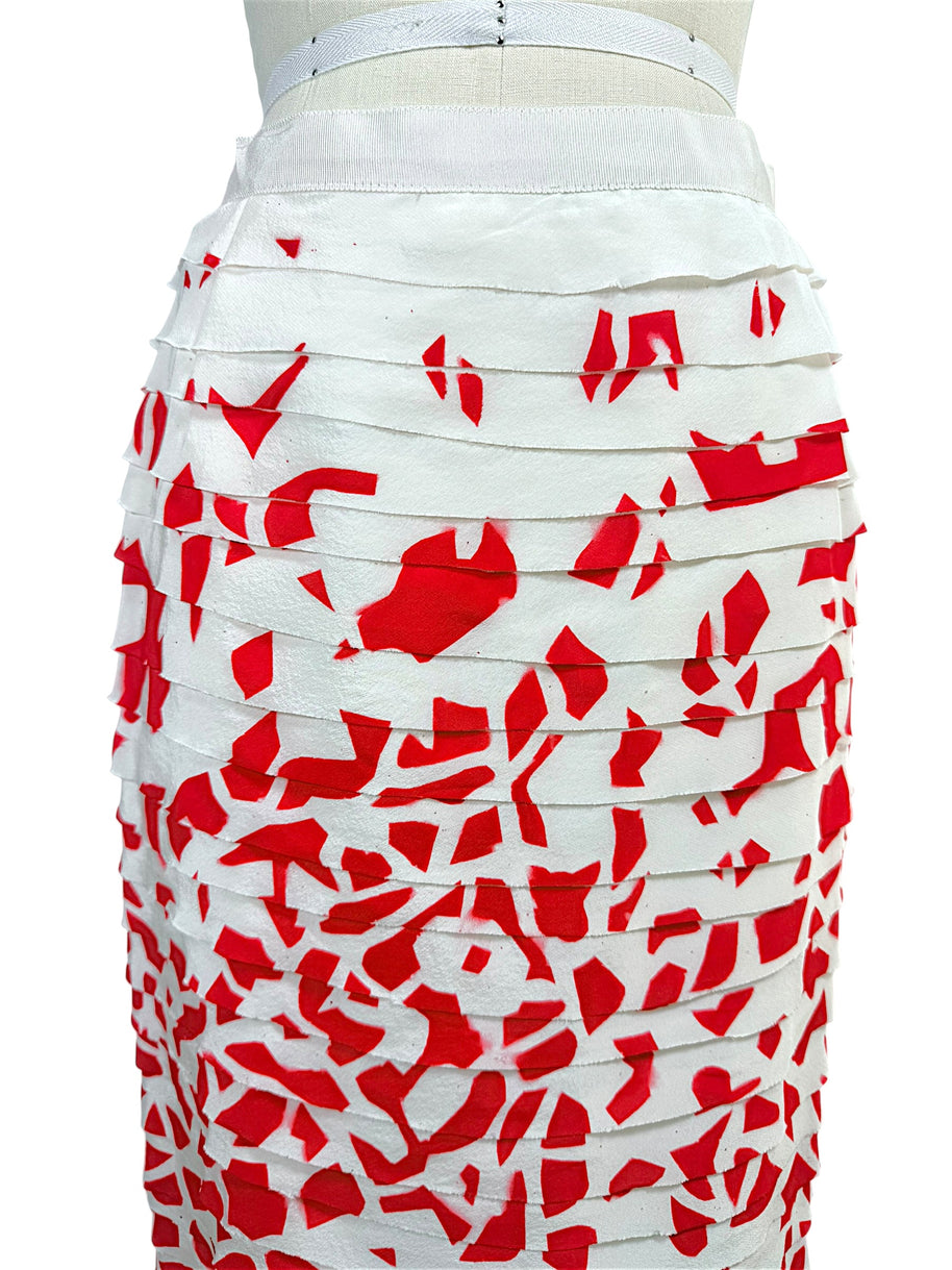 Close-up detail of Oscar de la Renta layered silk ribbon appliqué over vivid red abstract print fabric