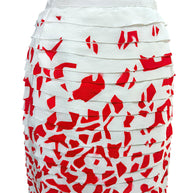 Close-up detail of Oscar de la Renta layered silk ribbon appliqué over vivid red abstract print fabric