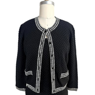 Front view of Oscar de la Renta black textured wool cardigan with black and white houndstooth trim and matching shell