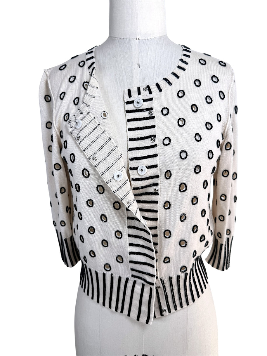 Oscar de la Renta ivory beaded cardigan shown partially open displaying concealed button front closure