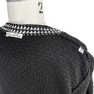 Close-up detail of Oscar de la Renta textured wool knit cardigan shoulder and contrast houndstooth trim